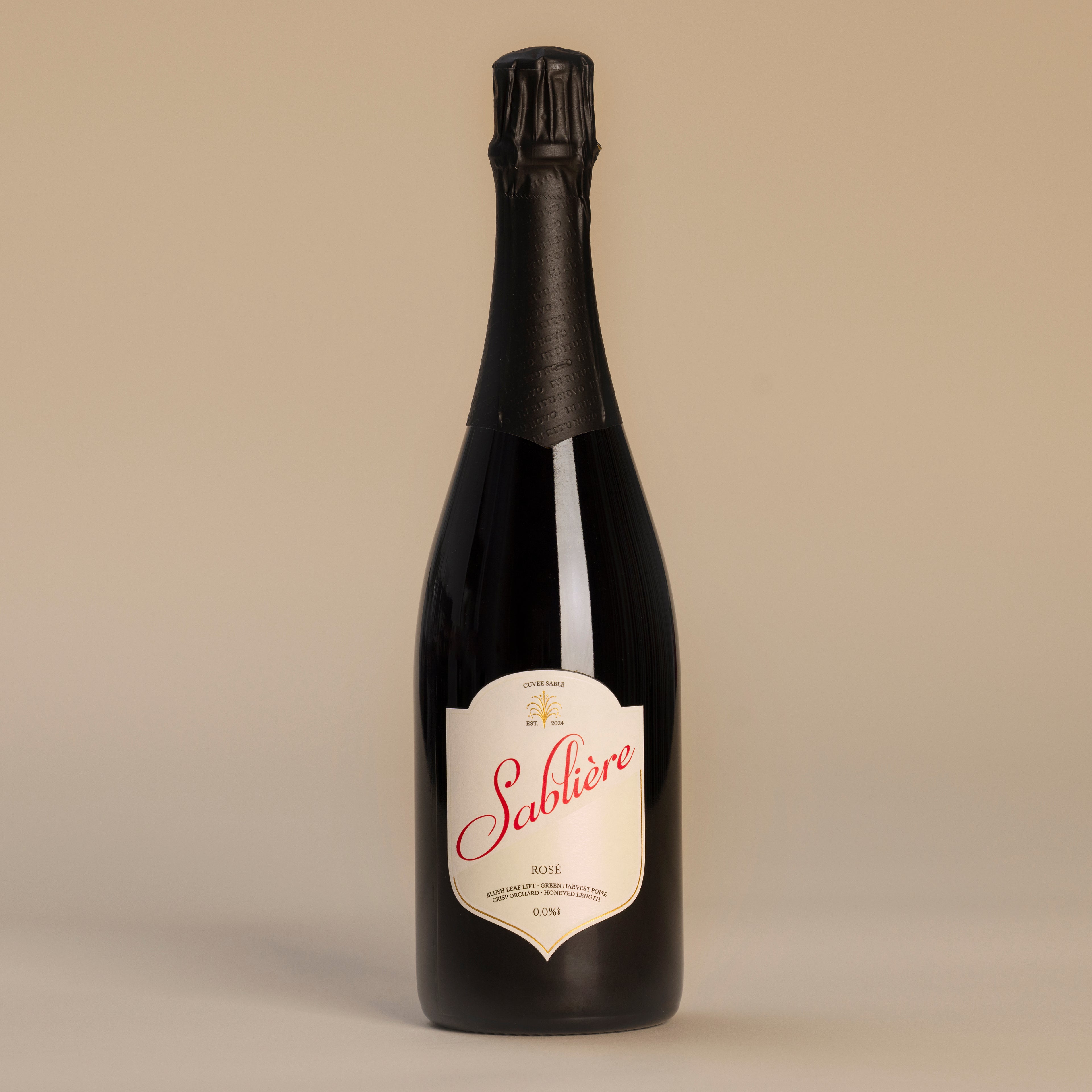 Black Cuvee bottle with 'Sablière' label on a beige background