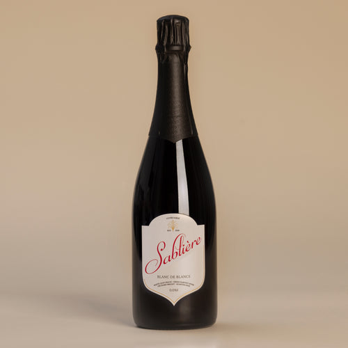 Bottle of Sableère wine with a beige label on a beige background